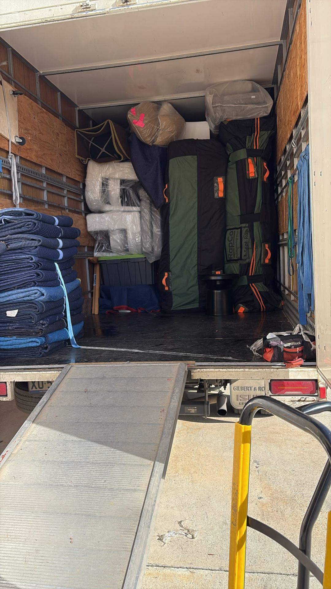 Truckmen crew carrying furniture out of a Canberra home on moving day