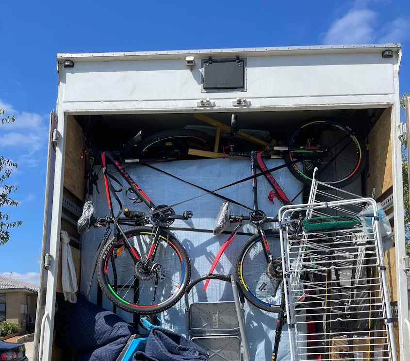 Bikes and household furniture securely strapped inside a Truckmen interstate removals truck