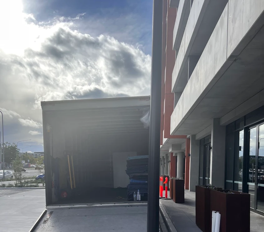 Truckmen removal truck at an apartment loading area in Canberra