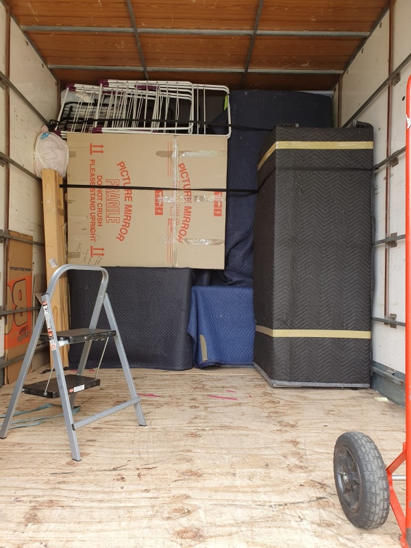 Truckmen removalists preparing a Canberra house move outside a home